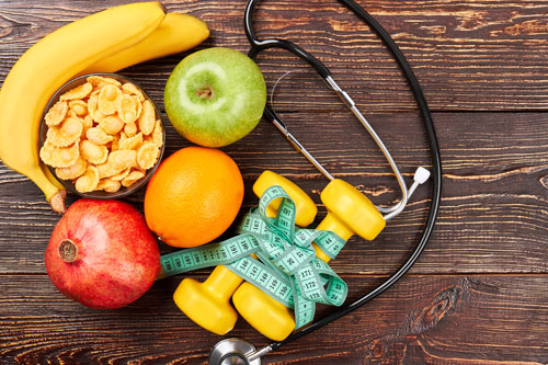 Image of fruits, a stethoscope, and measuring tape