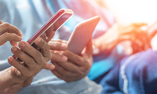 Close up shot of hands holding smart phones