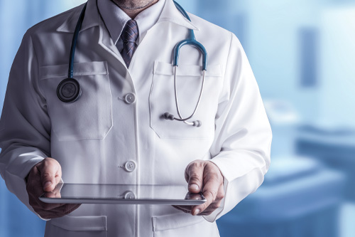 Male Doctor Holding Tablet Computer