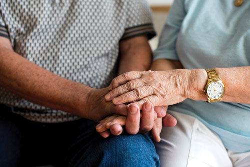 Older adults holding hands