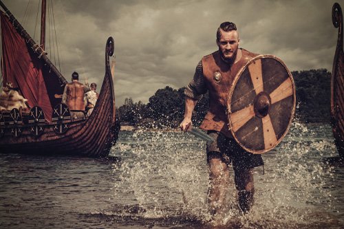 Viking walking out of the water with a sword